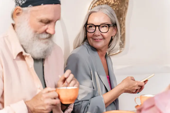 An older couple sharing coffee and conversation at home